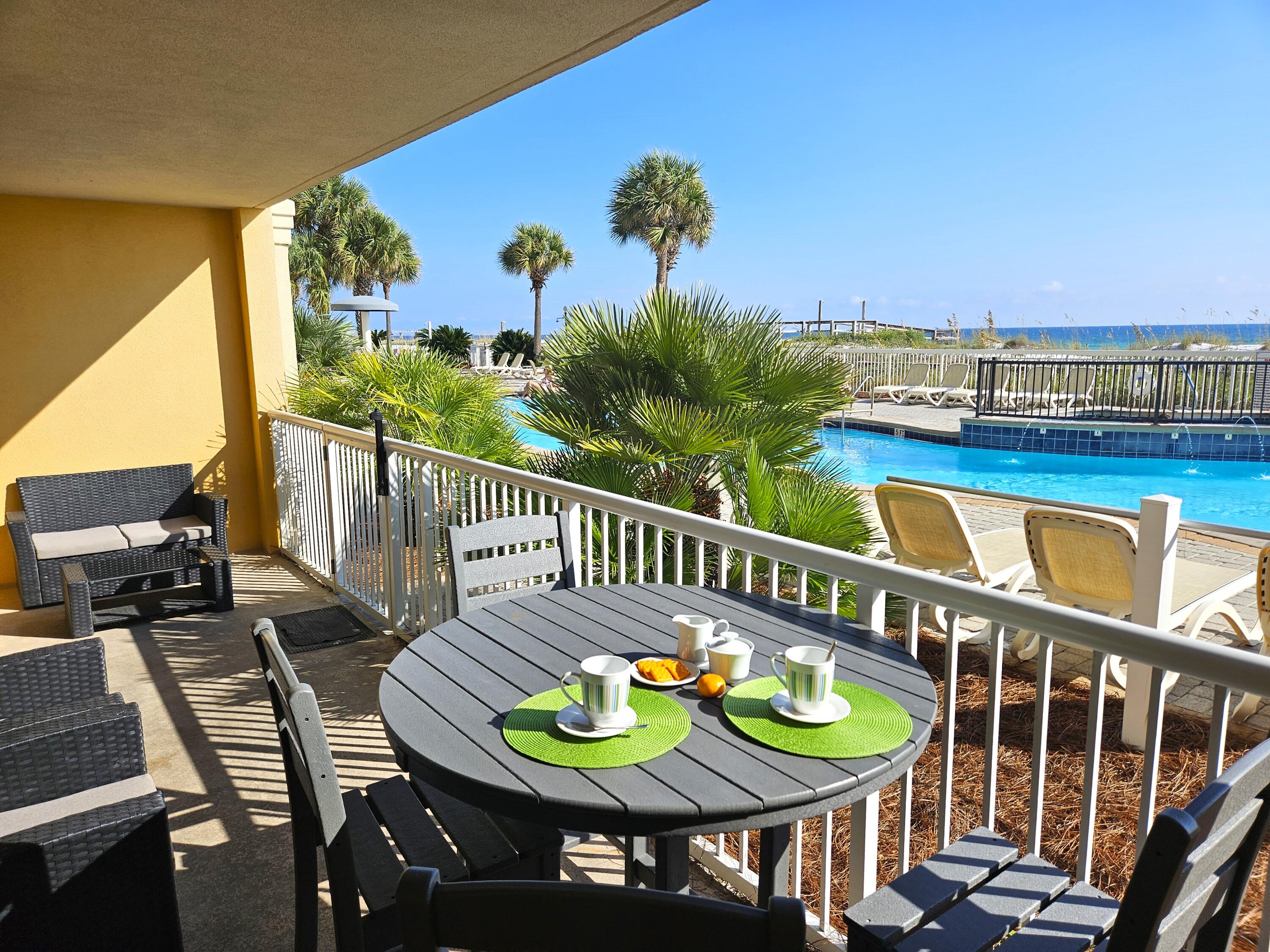 1150 Santa Rosa Boulevard, Unit 113 Fort Walton Beach, FL 32548 - Photo 2 of 71 a view of a balcony with chairs and wooden floor