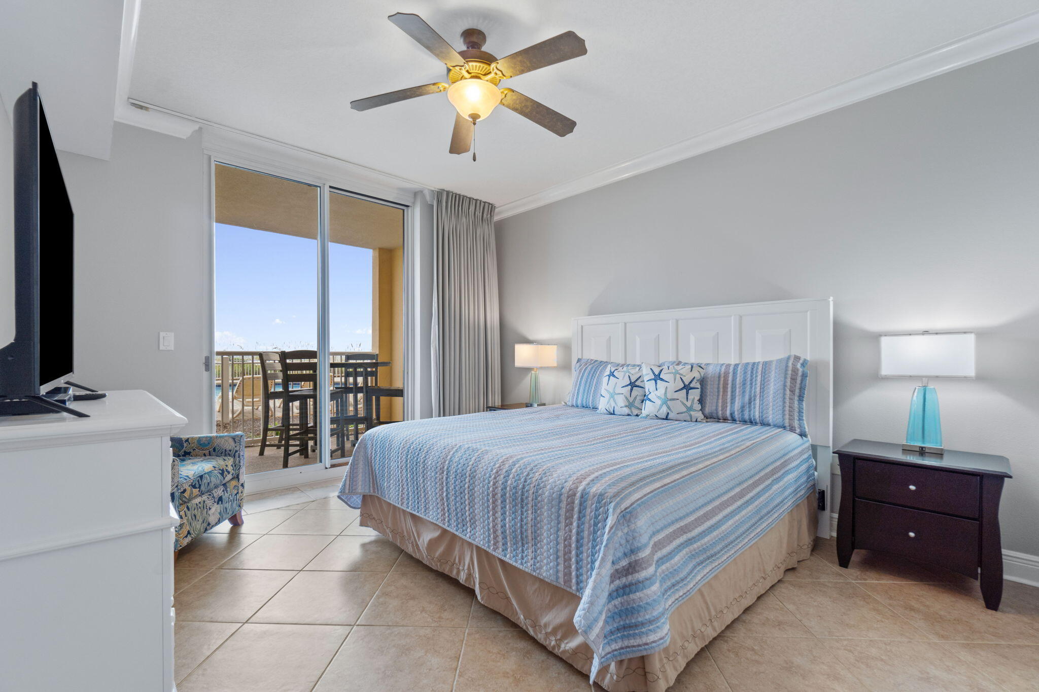1150 Santa Rosa Boulevard, Unit 113 Fort Walton Beach, FL 32548 - Photo 26 of 71 a bedroom with a bed and a chandelier