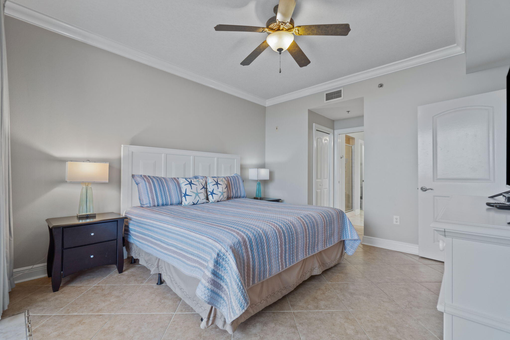 1150 Santa Rosa Boulevard, Unit 113 Fort Walton Beach, FL 32548 - Photo 27 of 71 a bedroom with a bed and a chandelier