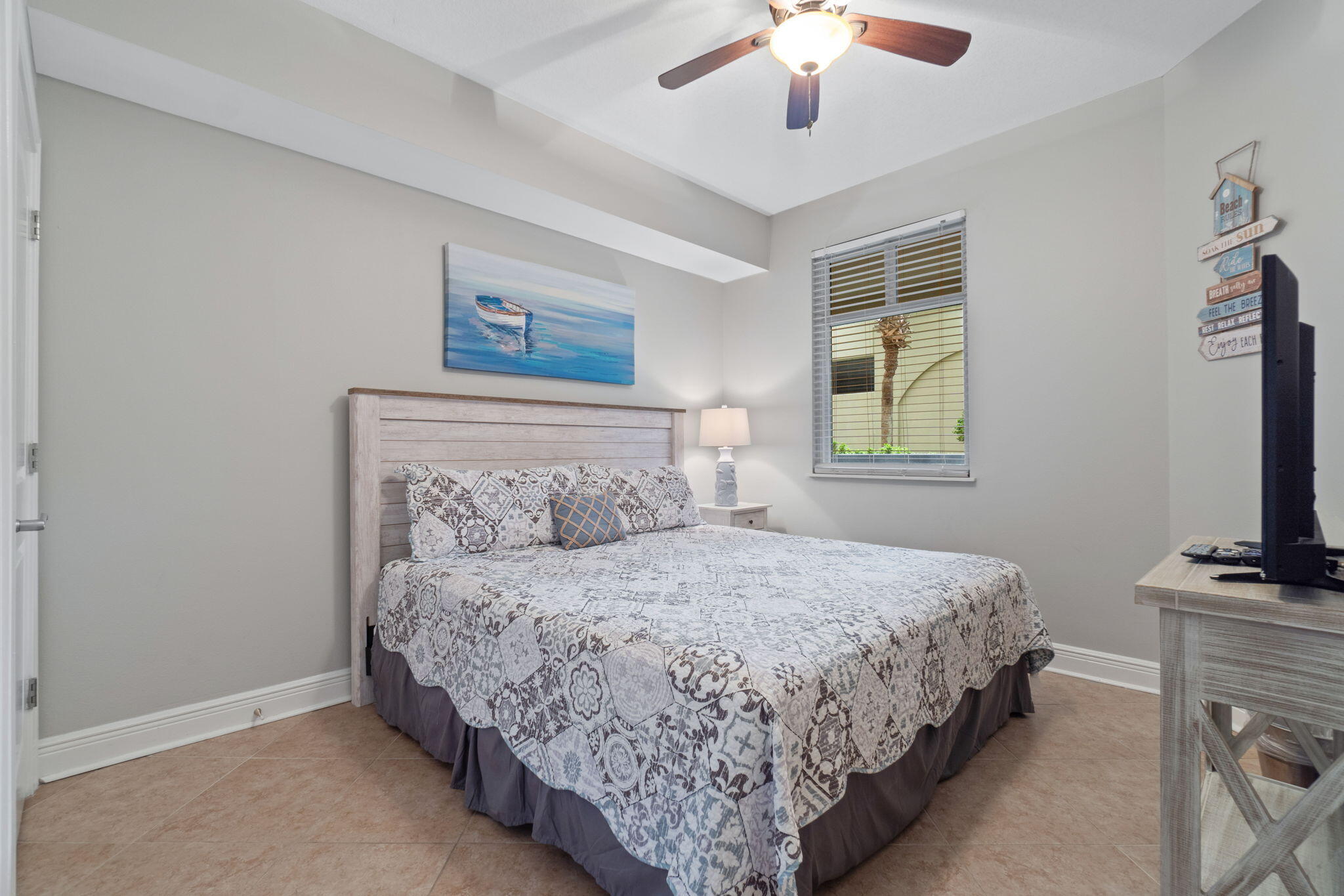 1150 Santa Rosa Boulevard, Unit 113 Fort Walton Beach, FL 32548 - Photo 35 of 71 a bedroom with double bed and a flat tv screen on a dresser