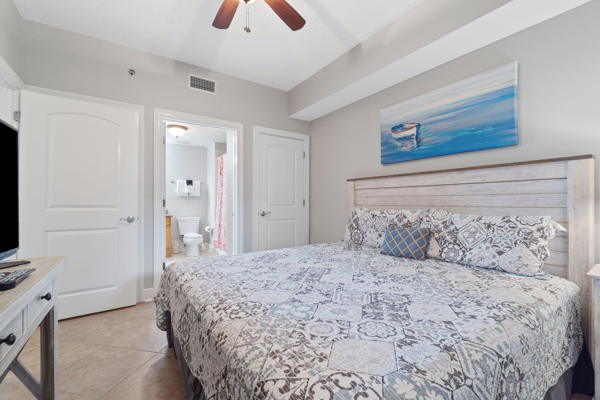1150 Santa Rosa Boulevard, Unit 113 Fort Walton Beach, FL 32548 - Photo 37 of 71 a bedroom with a large bed and a chandelier