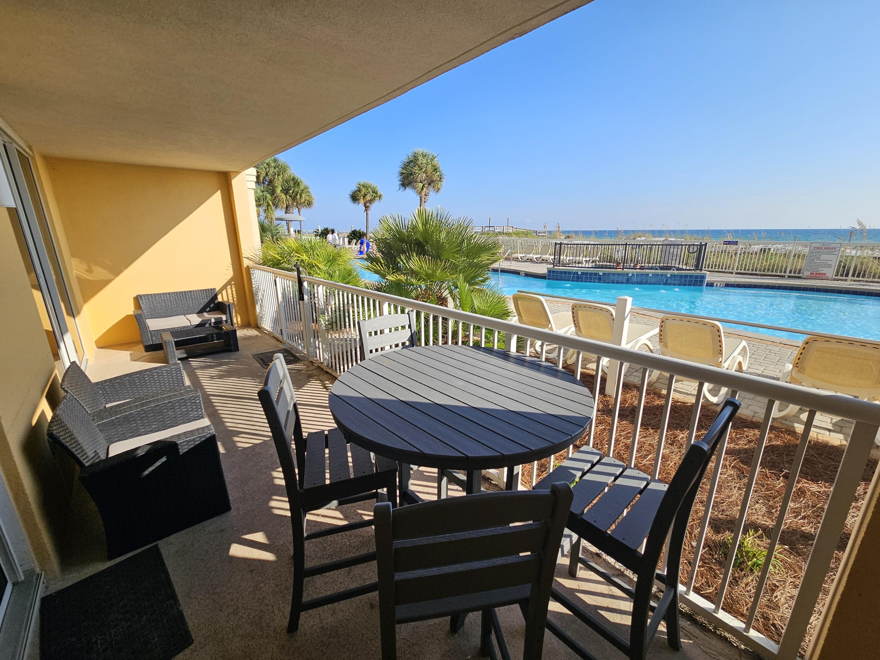 1150 Santa Rosa Boulevard, Unit 113 Fort Walton Beach, FL 32548 - Photo 45 of 71 a view of a chairs and table in patio