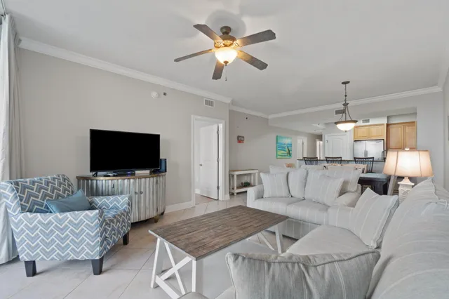 a living room with furniture and a chandelier