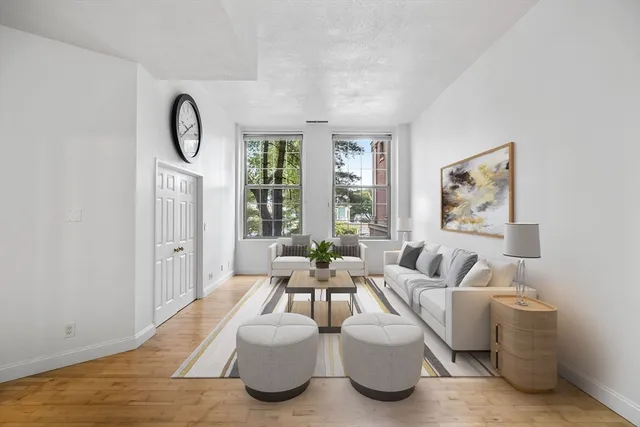 a living room with furniture a large window and flat screen tv