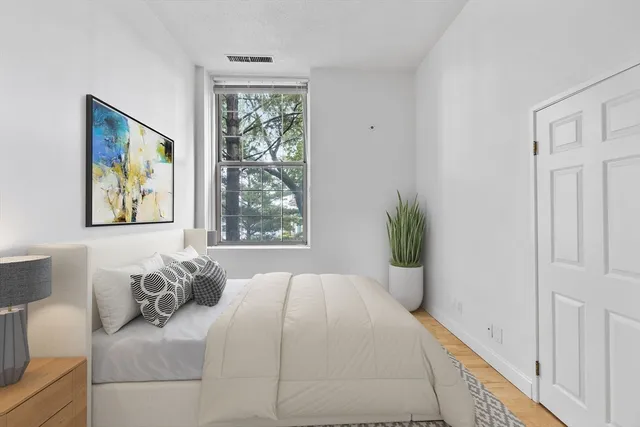 a bedroom with bed and a window