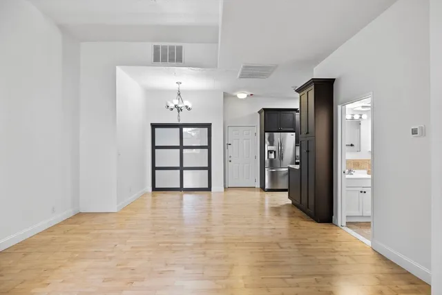 a view of a kitchen with a sink and a refrigerator