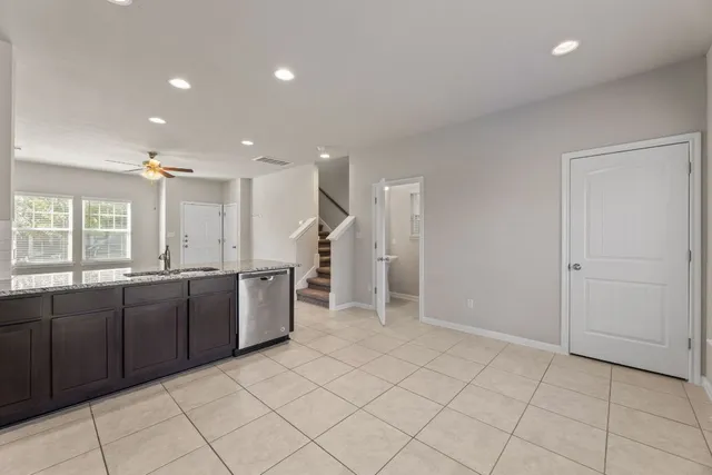 a large kitchen with a sink and cabinets