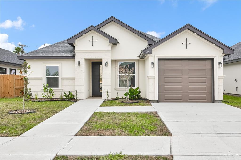 3516 East Alexa Street Edinburg, TX 78542 - Photo 1 of 25 a front view of a house with a yard and garage