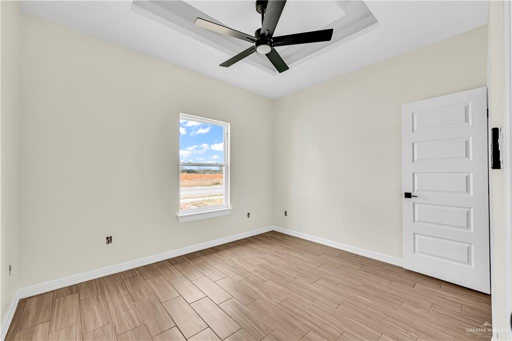 3516 East Alexa Street Edinburg, TX 78542 - Photo 14 of 25 a view of empty room with wooden floor and fan