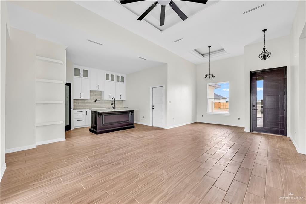 3516 East Alexa Street Edinburg, TX 78542 - Photo 18 of 25 a view of a livingroom with a furniture wooden floor and a ceiling fan