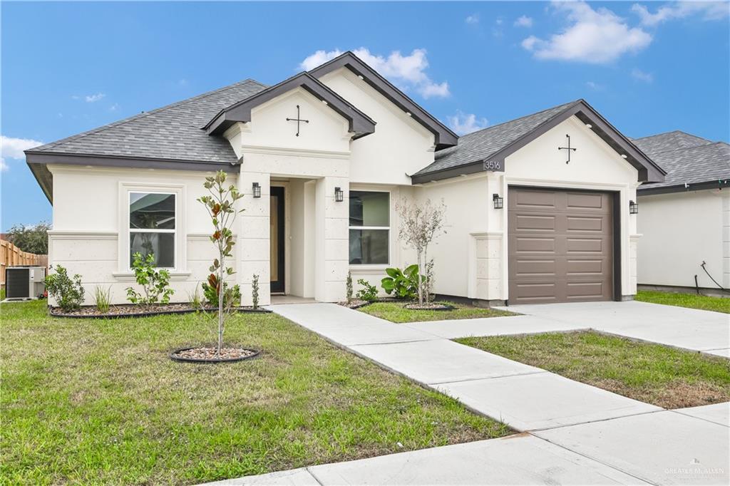 3516 East Alexa Street Edinburg, TX 78542 - Photo 3 of 25 a front view of a house with a yard and garage