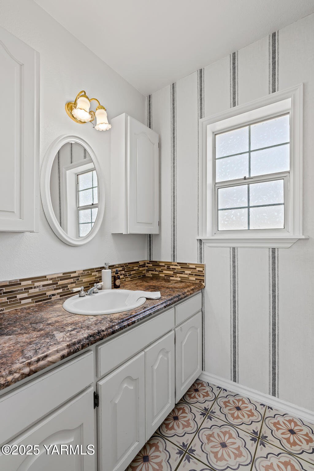 11809 Occidental Road Yakima, WA 98908 - Photo 25 of 60 a bathroom with a granite countertop sink and a mirror
