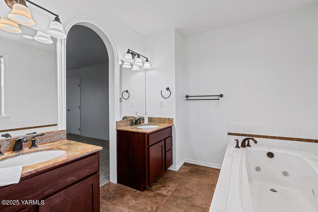 11809 Occidental Road Yakima, WA 98908 - Photo 34 of 60 a utility room with cabinets washer and dryer