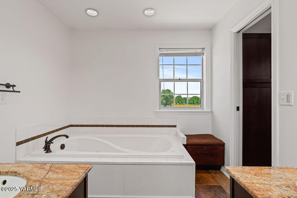 11809 Occidental Road Yakima, WA 98908 - Photo 35 of 60 a bathroom with a bathtub and next to a window