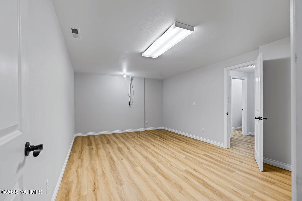 11809 Occidental Road Yakima, WA 98908 - Photo 43 of 60 a view of empty room with wooden floor