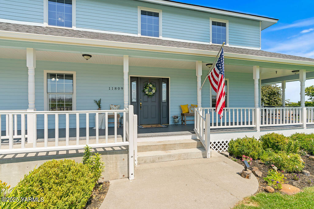 11809 Occidental Road Yakima, WA 98908 - Photo 6 of 60 a view of a house with a small yard and flower plants