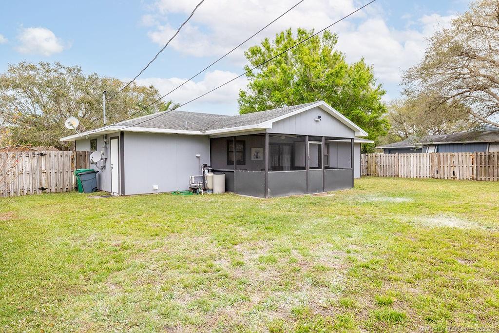 6803 Salerno Road Fort Pierce, FL 34951 - Photo 13 of 65 a front view of a house with a garden