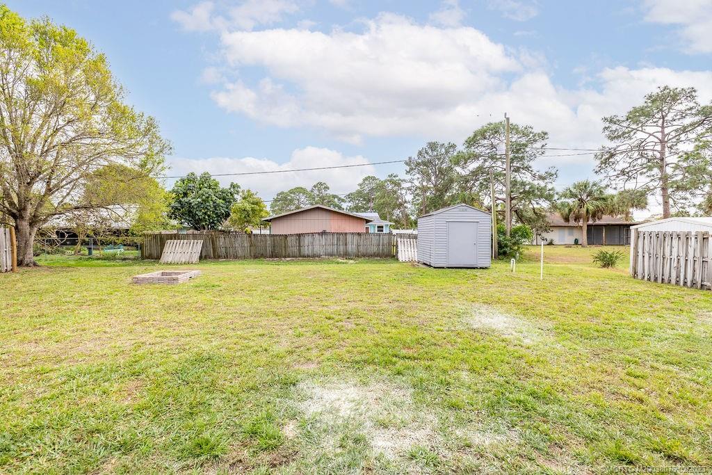6803 Salerno Road Fort Pierce, FL 34951 - Photo 18 of 65 a swimming pool with outdoor seating and yard