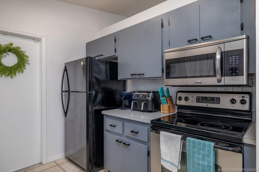 6803 Salerno Road Fort Pierce, FL 34951 - Photo 30 of 65 a kitchen with a refrigerator stove and microwave