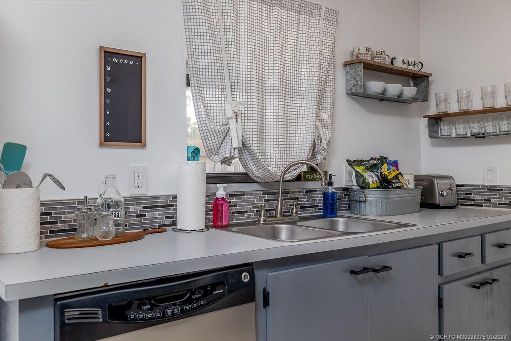 6803 Salerno Road Fort Pierce, FL 34951 - Photo 32 of 65 a kitchen with a sink and cabinets