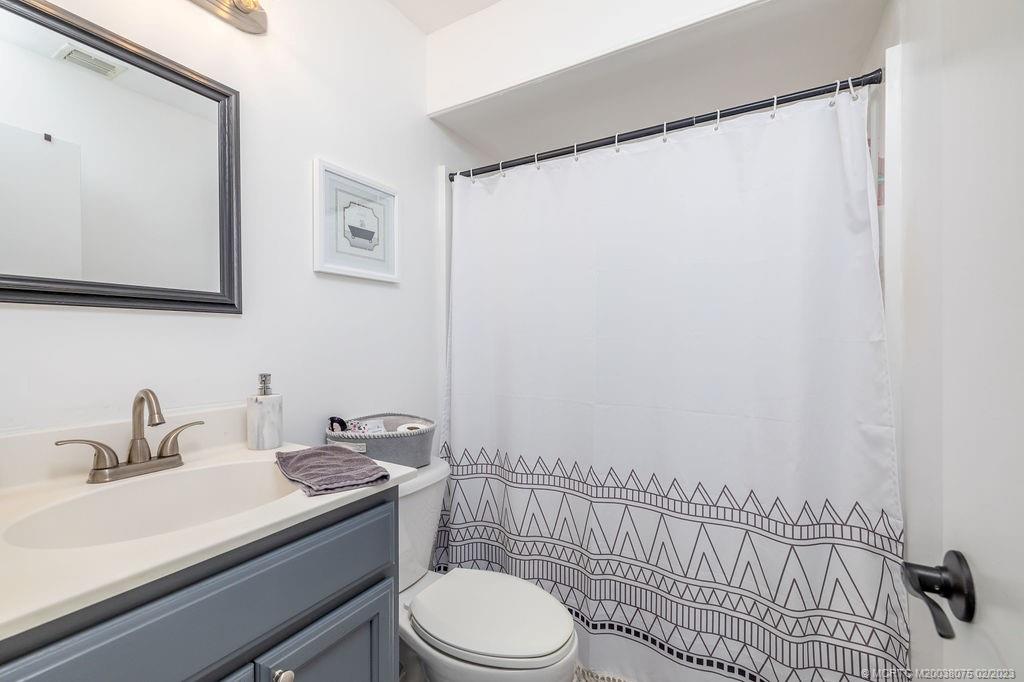 6803 Salerno Road Fort Pierce, FL 34951 - Photo 39 of 65 a bathroom with a sink a toilet and a shower