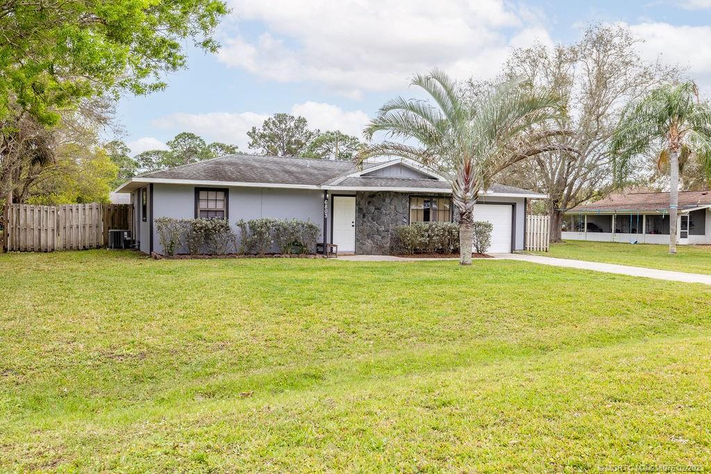 6803 Salerno Road Fort Pierce, FL 34951 - Photo 4 of 65 a front view of house with yard and green space
