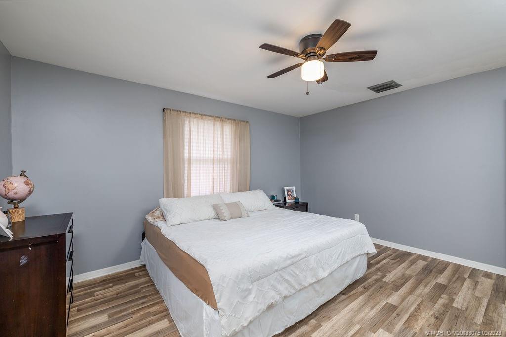 6803 Salerno Road Fort Pierce, FL 34951 - Photo 44 of 65 a bedroom with a large bed and a window