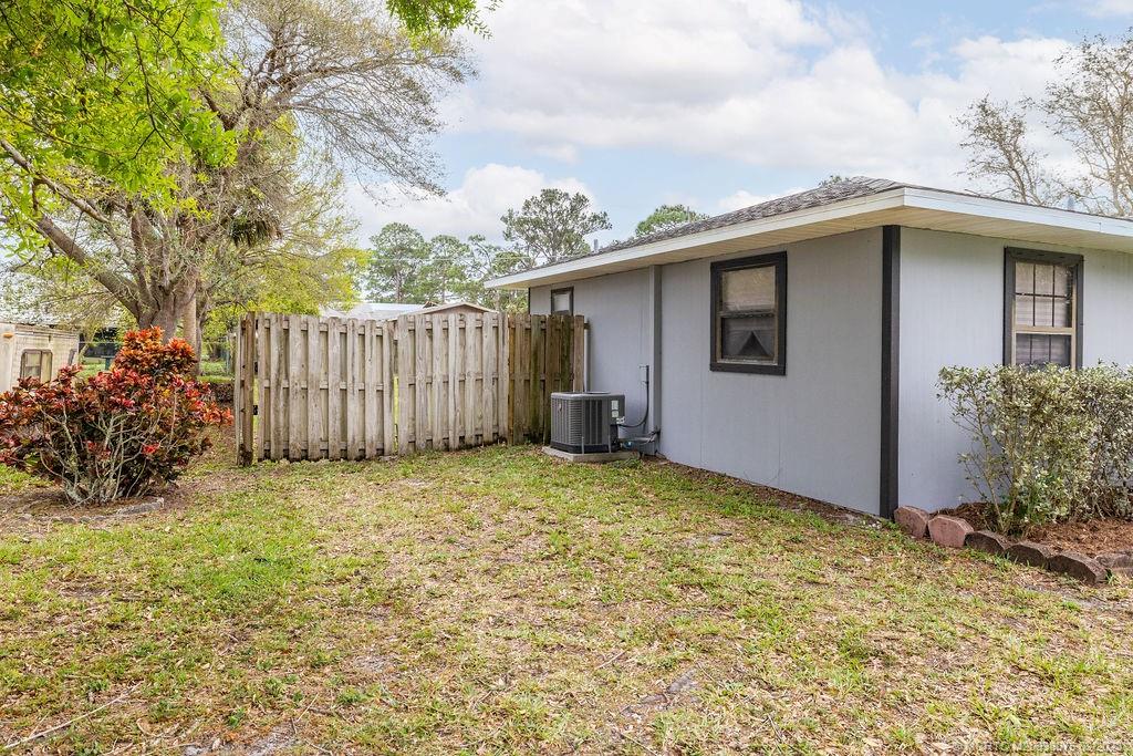 6803 Salerno Road Fort Pierce, FL 34951 - Photo 5 of 65 a backyard of a house with lots of green space