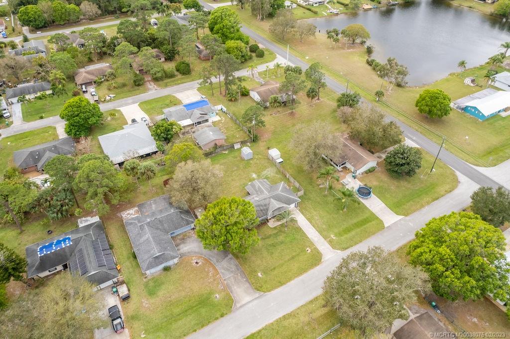 6803 Salerno Road Fort Pierce, FL 34951 - Photo 56 of 65 an aerial view of a house with a yard and lake view