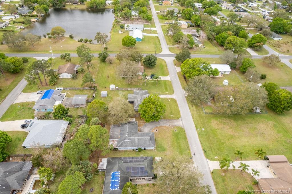 6803 Salerno Road Fort Pierce, FL 34951 - Photo 57 of 65 an aerial view of residential houses with outdoor space