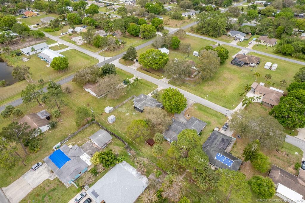 6803 Salerno Road Fort Pierce, FL 34951 - Photo 58 of 65 an aerial view of a residential houses with yard
