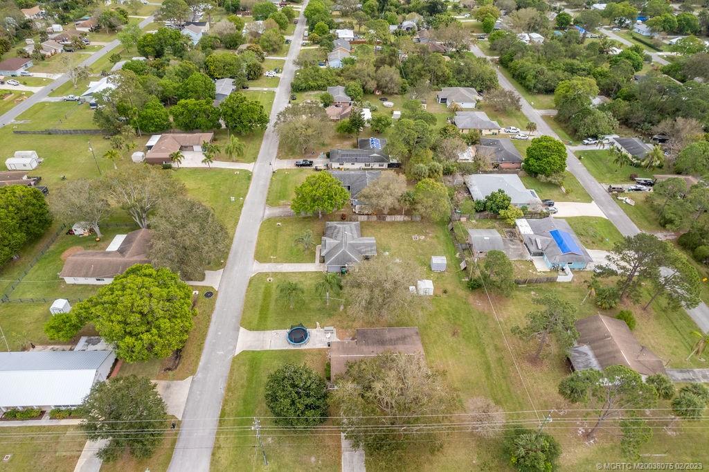 6803 Salerno Road Fort Pierce, FL 34951 - Photo 61 of 65 an aerial view of residential houses with outdoor space