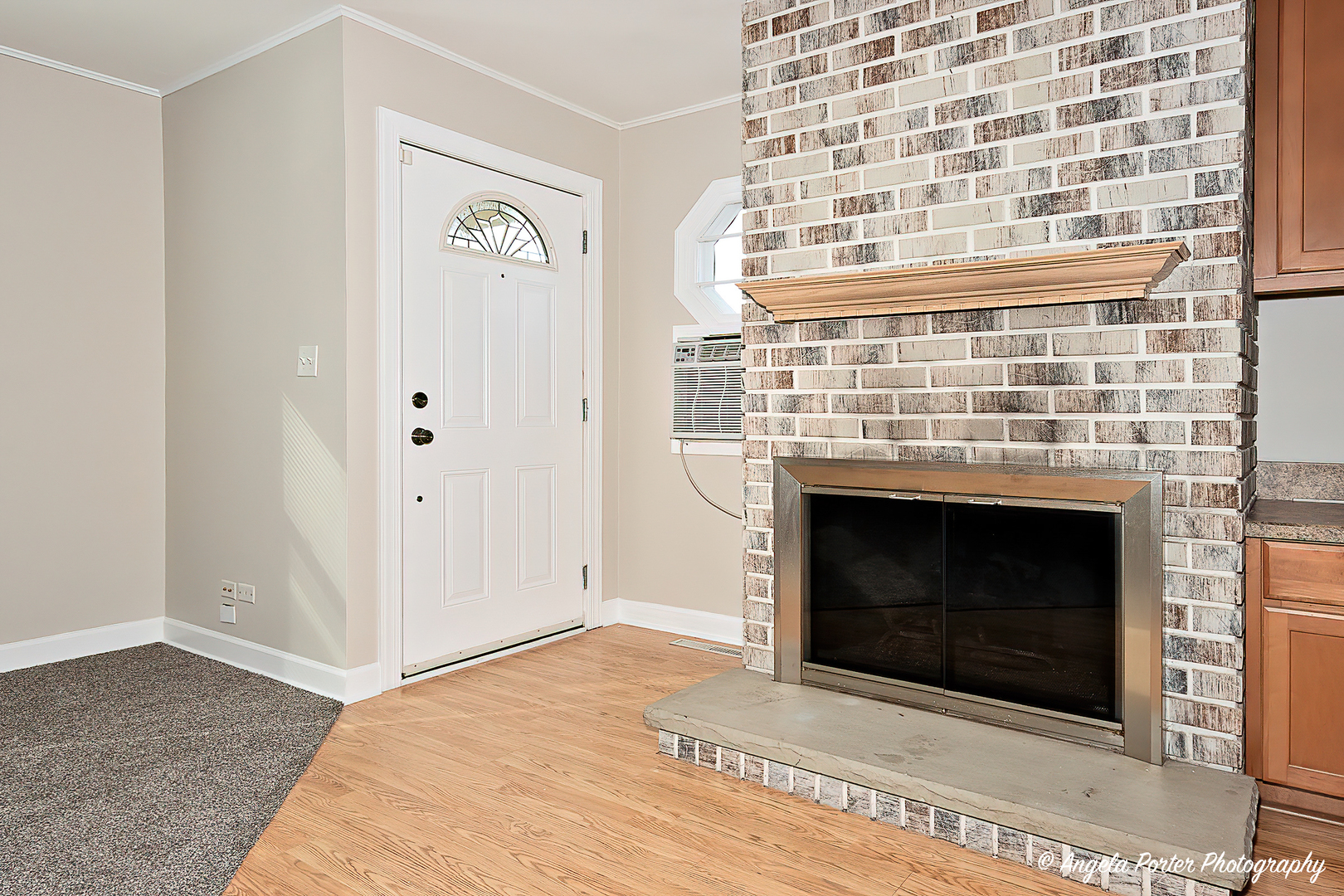 238 Woodland Road Libertyville, IL 60048 - Photo 3 of 19 a view of an empty room with wooden floor and a fireplace