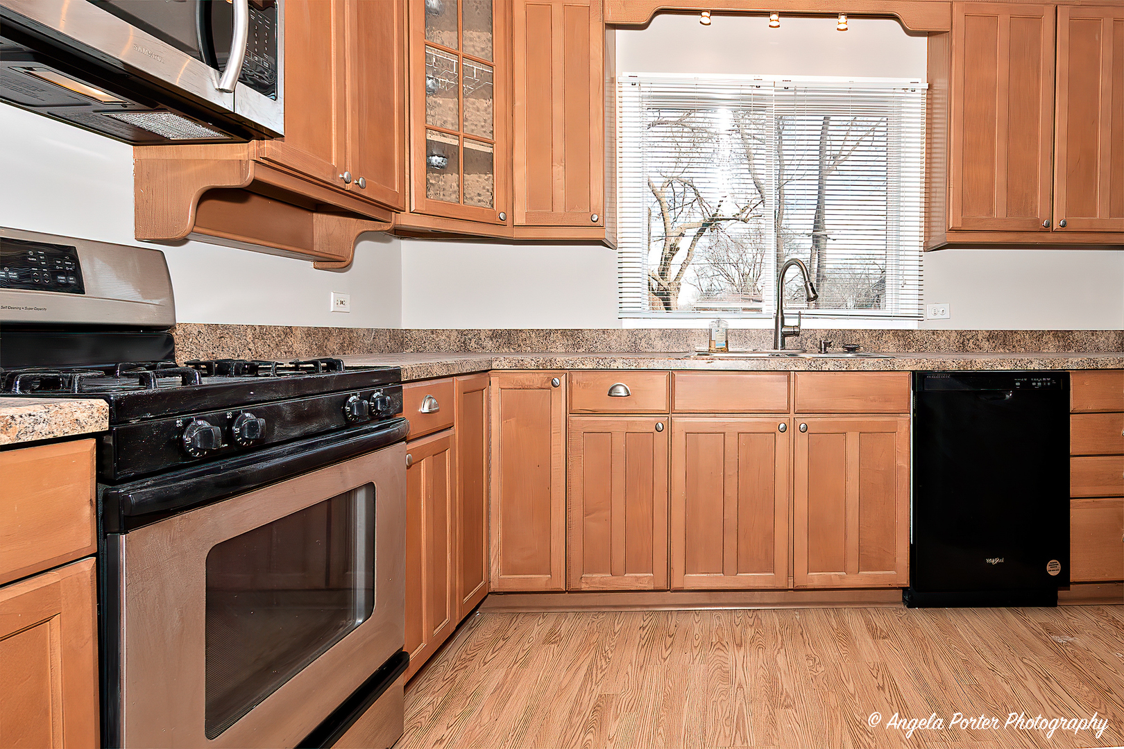 238 Woodland Road Libertyville, IL 60048 - Photo 8 of 19 a kitchen with granite countertop a stove a sink and a microwave