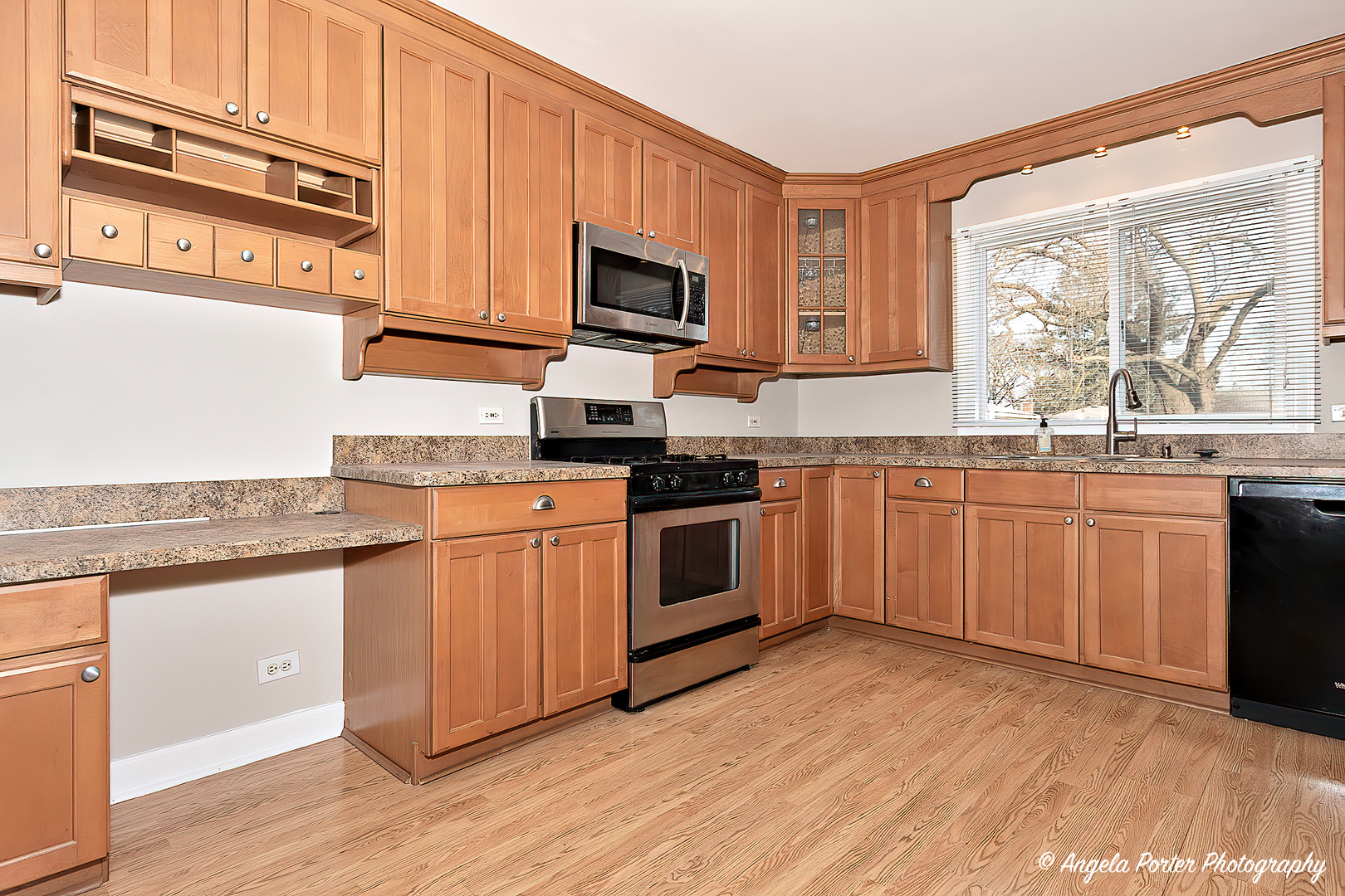 238 Woodland Road Libertyville, IL 60048 - Photo 9 of 19 a kitchen with stainless steel appliances granite countertop a stove a sink and white cabinets