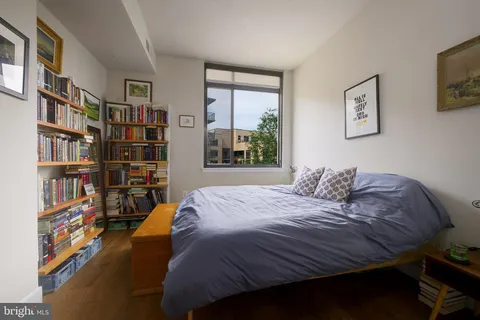 a bedroom with a bed and a chair