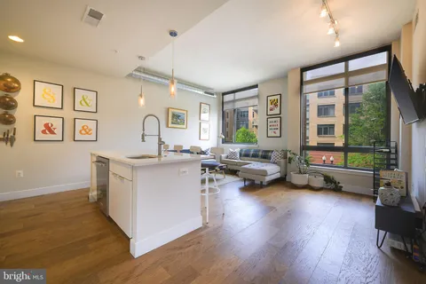 a kitchen with stainless steel appliances kitchen island granite countertop a sink and cabinets