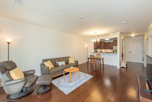 a living room with furniture and kitchen view