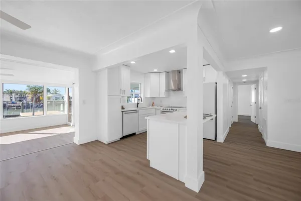 a kitchen with stainless steel appliances a stove top oven a sink and a refrigerator