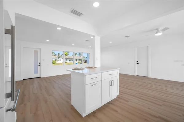a kitchen with white cabinets and white appliances