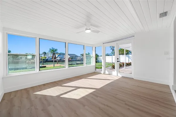 en empty room with wooden floor and outdoor view
