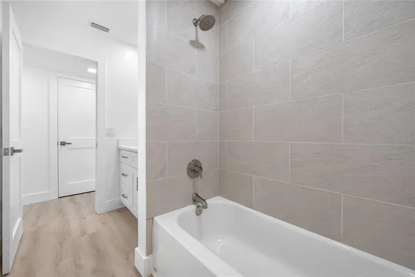 a bedroom with bed and a potted plant