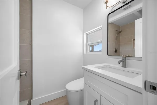 a bathroom with a sink toilet and mirror