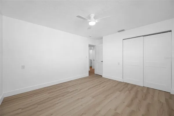 a view of a work space with wooden floor and a window