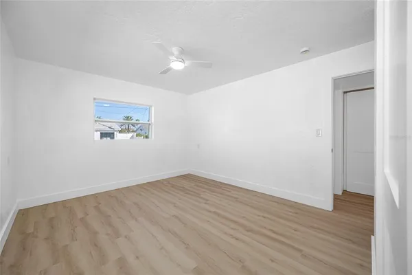 a view of a workspace with wooden floor and a chandelier fan