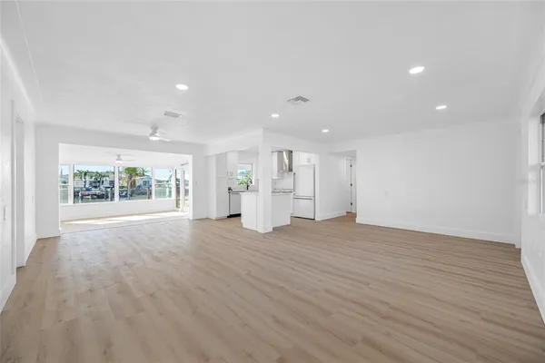 a living room with furniture a rug and a kitchen view