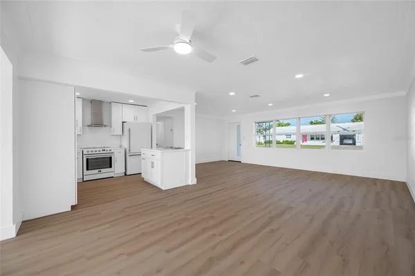 a view of a kitchen with a sink and a refrigerator
