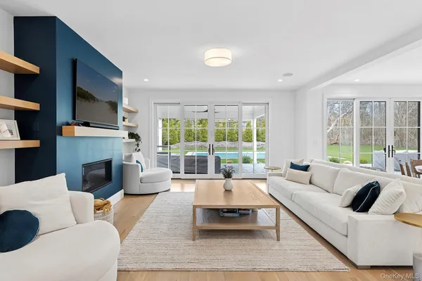 a living room with furniture large window and fireplace