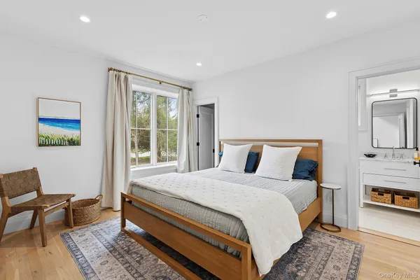 a bed room with a bed and a chair