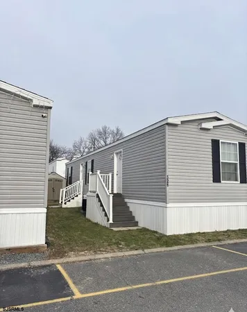 a view of a house with a space and a parking space